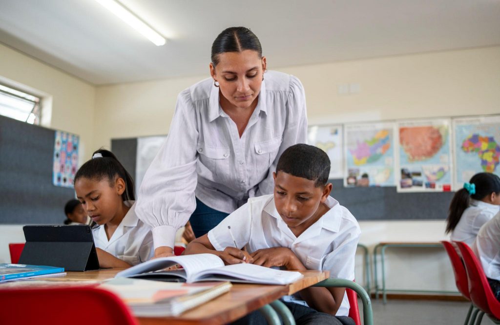 Teacher helping high school learners prepare for examinations